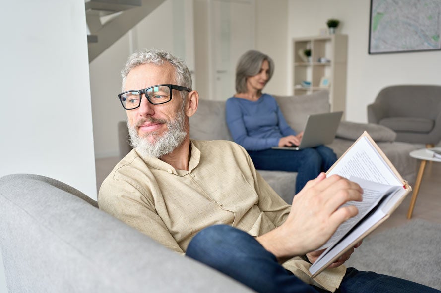 Couple reading books in living room